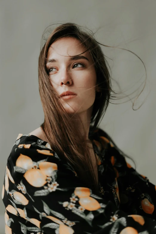 a woman with her hair blowing in the wind, by irakli nadar, trending on pexels, hyperrealism, patterned clothing, serious focussed look, young woman with long dark hair, close - up studio photo