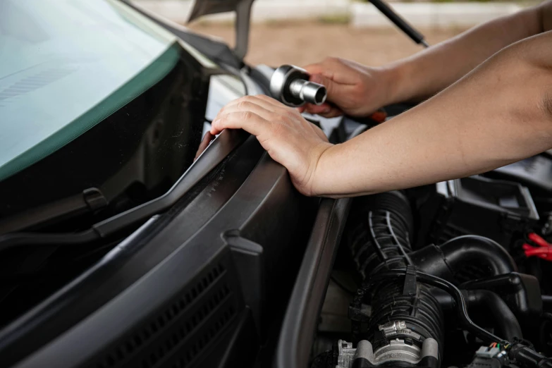 a person fixing the hood of a car, shutterstock, renaissance, finely detailed features, avatar image, hoses, detail shot