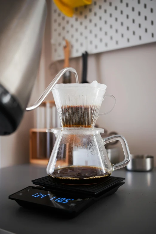 a coffee maker sitting on top of a kitchen counter, glassware, thumbnail, volcanic, pouring