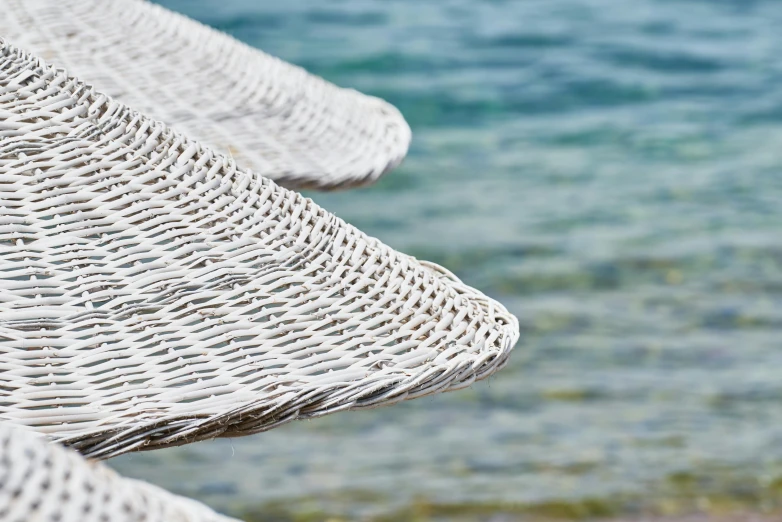 a number of umbrellas near a body of water, inspired by Nassos Daphnis, pexels contest winner, wicker chair, white mechanical details, detail shot, mediterranean