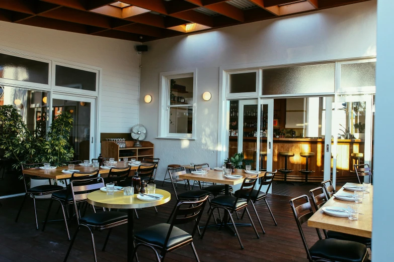 the inside of a restaurant with lots of tables and chairs