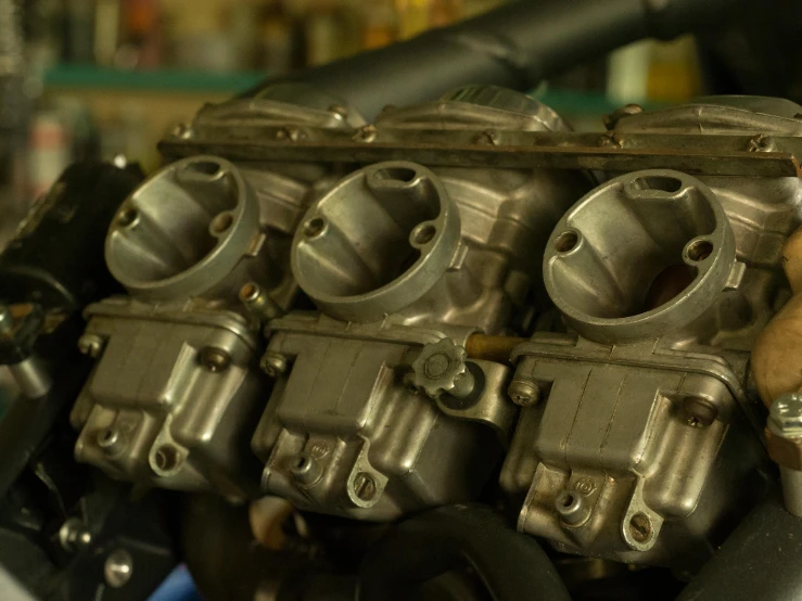 a close up of a motorcycle engine in a garage, reddit, fan favorite, vintage race footage, panels, void manifold