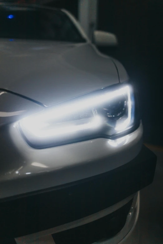 the headlights of a modern silver car