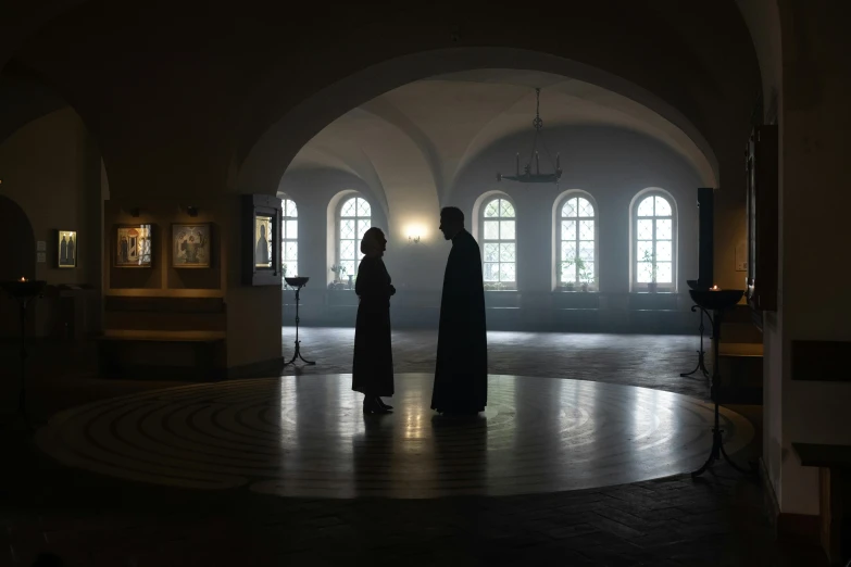 a couple of people that are standing in a room, by Marina Abramović, pexels contest winner, in orthodox church, movie set, robed, inside covens den