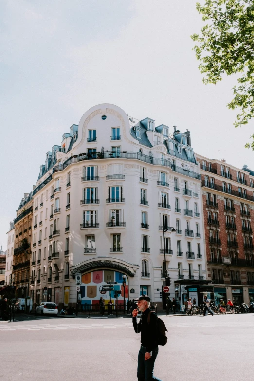 a person riding a skateboard on a city street, a photo, trending on unsplash, paris school, multistory building, rounded roof, french village exterior