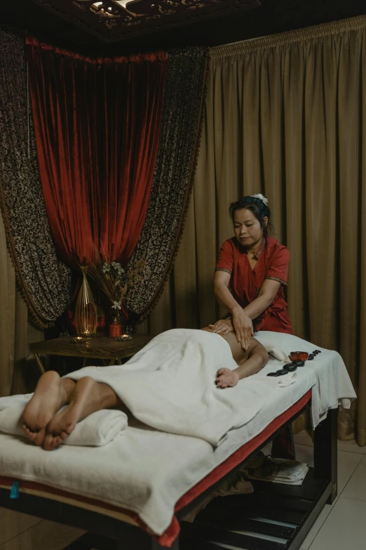 a woman getting a massage at a spa, a portrait, by Basuki Abdullah, layed on a red velvet fabric, thumbnail, scene from a movie, high quality upload