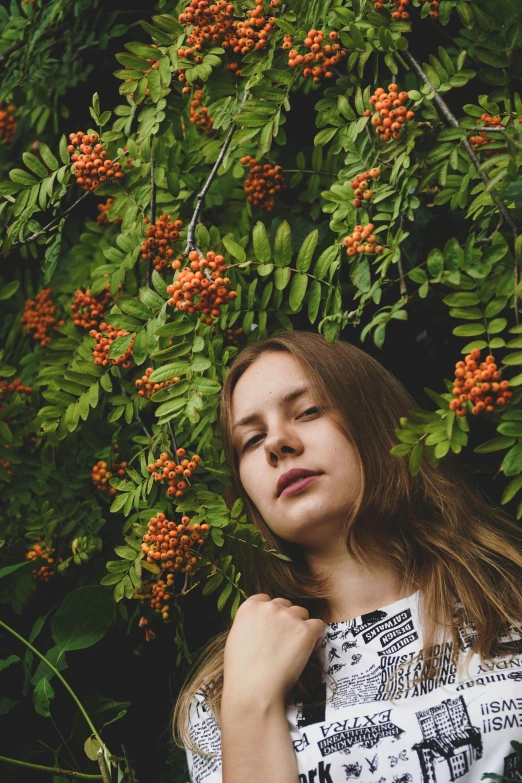 a beautiful woman posing in front of some orange flowers