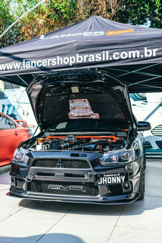 a car that is sitting under a tent, by Emerson Silva, in a modified nissan skyline r34, são paulo, avatar image, shops