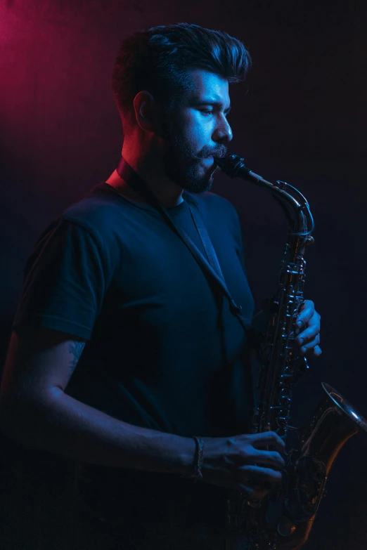 the man is playing a saxophone on a dark background