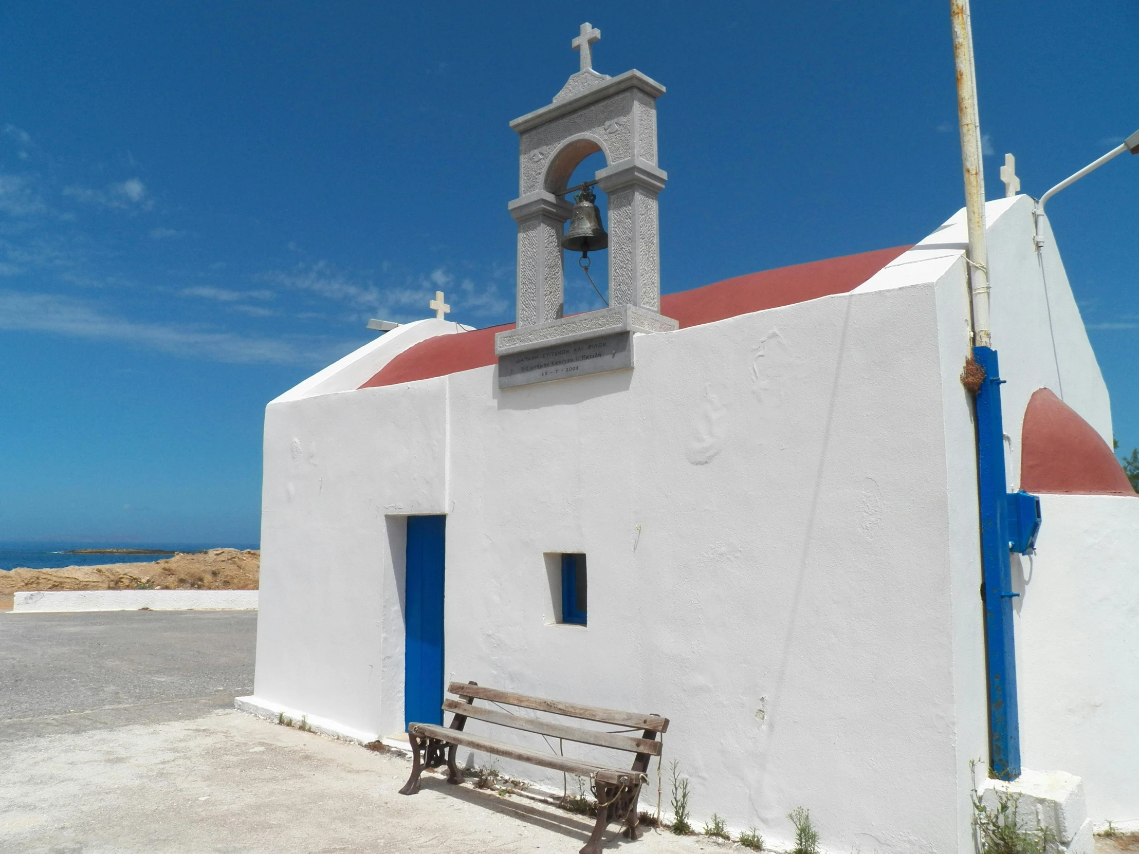 a white church with a red roof and a blue door, inspired by Antonín Chittussi, pexels contest winner, square, alvaro siza, seaside, brown