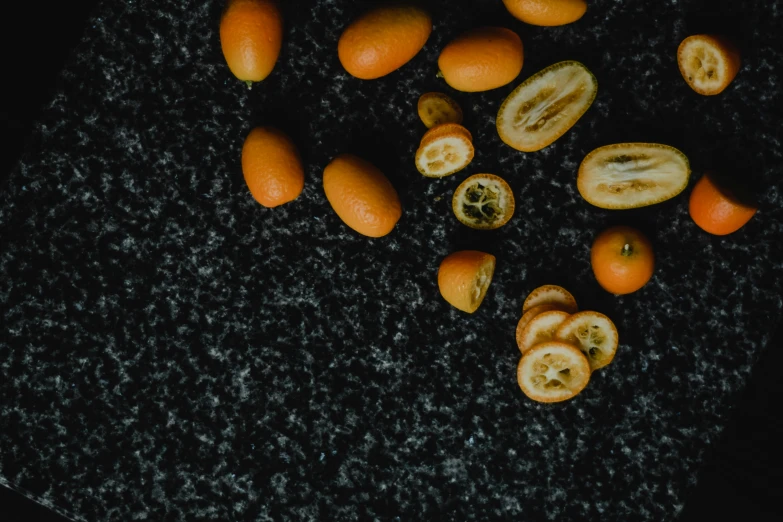 a bunch of oranges sitting on top of a table, by Carey Morris, pexels contest winner, grey, smooth tiny details, background image, miniatures