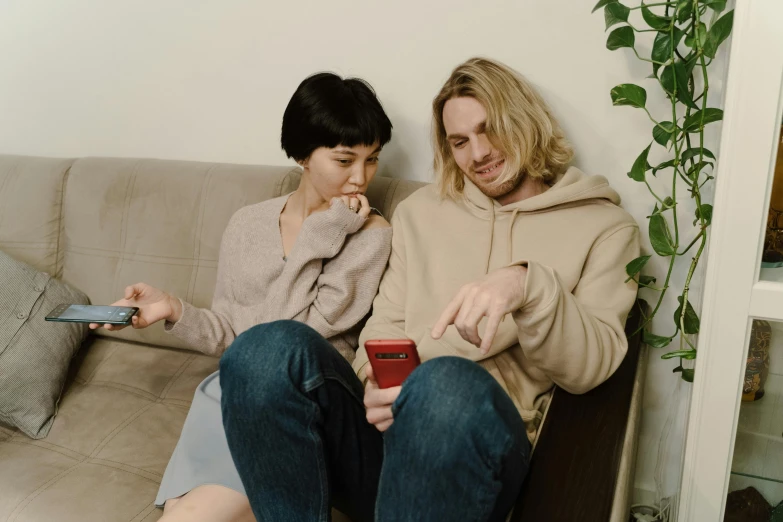 a couple of people that are sitting on a couch, trending on pexels, happening, russian and japanese mix, smartphone, casey cooke, very very low quality picture