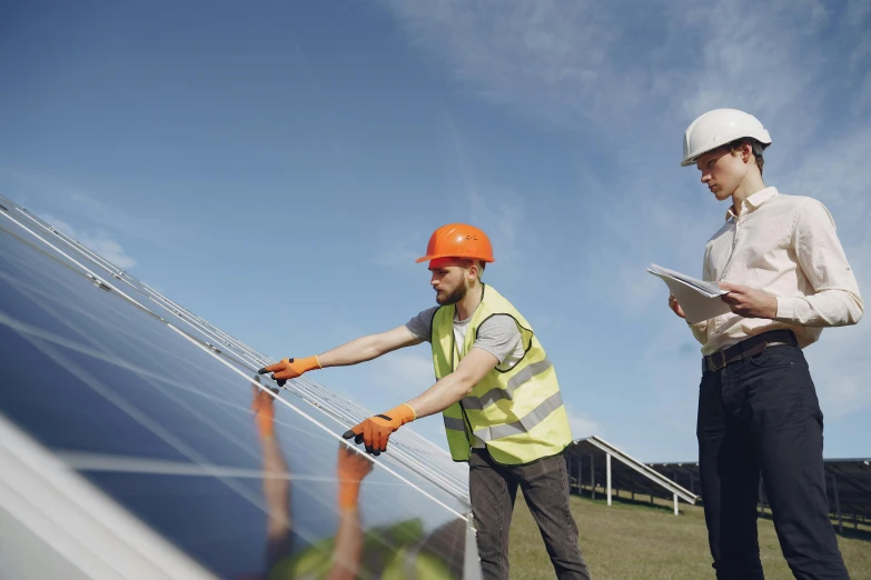 a couple of men standing next to each other on a field, solar panels, avatar image, 2263539546], worksafe. cinematic