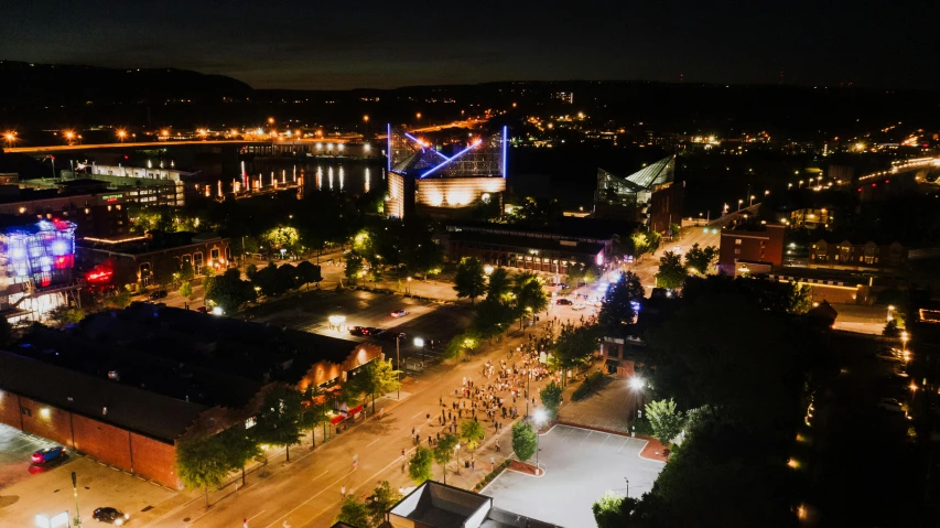 an aerial view of a city at night, a picture, happening, music festival, looking over west virginia, outdoor photo, full res