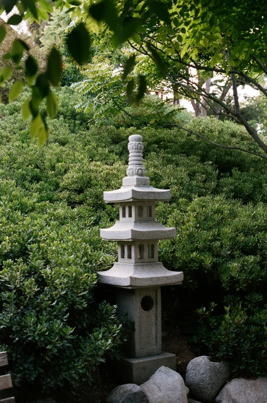 a garden with large rocks and green trees