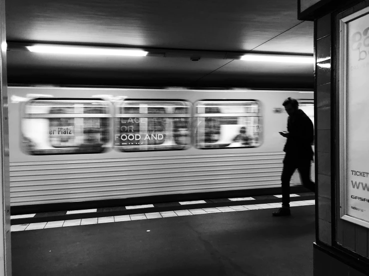 black and white pograph of people waiting for a train