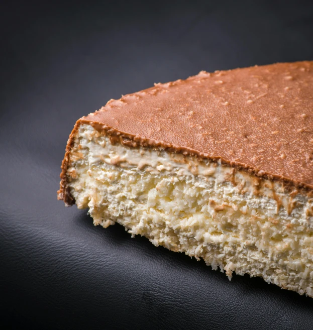 a piece of cake sitting on top of a black surface, traditional corsican, high quality product image”, maison laffite, patagonian