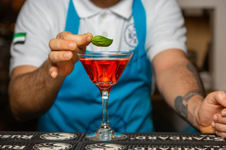 a bartender prepares a drink at a bar, a portrait, inspired by Carlo Martini, pexels contest winner, private press, avatar image, indigo and venetian red, basil, thumbnail