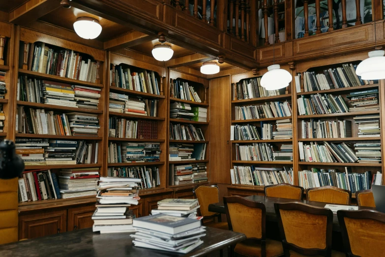 a large library filled with lots of books, a portrait, unsplash, private press, papers on table, azamat khairov, jen atkin, thumbnail