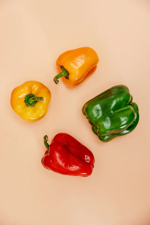 a group of peppers sitting on top of a white plate, renaissance, in front of an orange background, detailed product image, zoomed in, organic shape