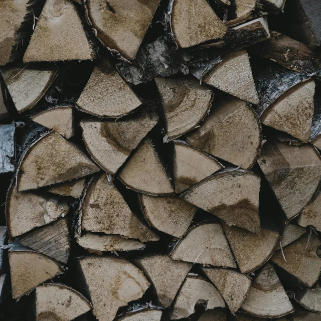 a pile of wood stacked on top of each other, by Jesper Knudsen, pexels contest winner, fan favorite, grey, burned, thick lining