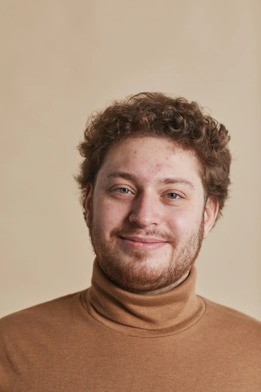 a man in a brown turtle neck sweater, by Daniel Seghers, trending on reddit, he has short curly brown hair, clear background, ignant, friendly face
