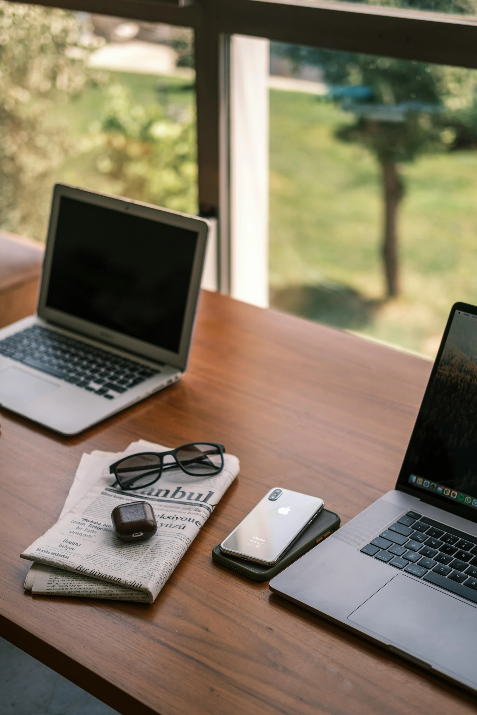 a couple of laptops sitting on top of a wooden table, sitting at a desk, indiecraft aesthetic, journalism, nomad