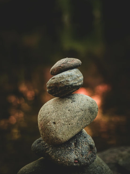 a stack of rocks sitting on top of each other, a statue, unsplash, paul barson, low quality photo, fire lit, actual photo