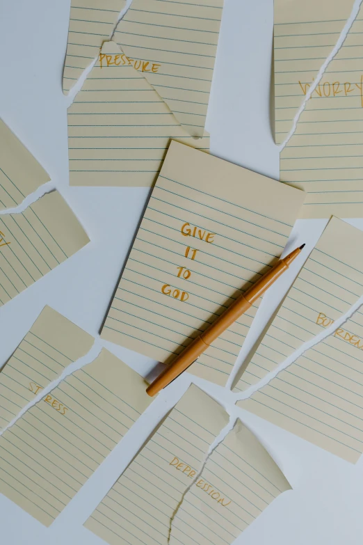 a bunch of pieces of paper with writing on them, holding pencil, golden linings, thumbnail, shot onfilm