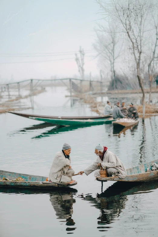 a couple of people in small boats on a body of water, a picture, inspired by Steve McCurry, pexels contest winner, hurufiyya, winter season, villages, calmly conversing 8k, desi