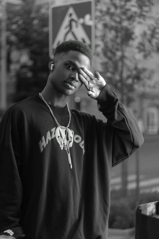 a black and white photo of a man in a hoodie, inspired by Xanthus Russell Smith, confident pose, bladee from drain gang, in the golden hour, slightly turned to the right