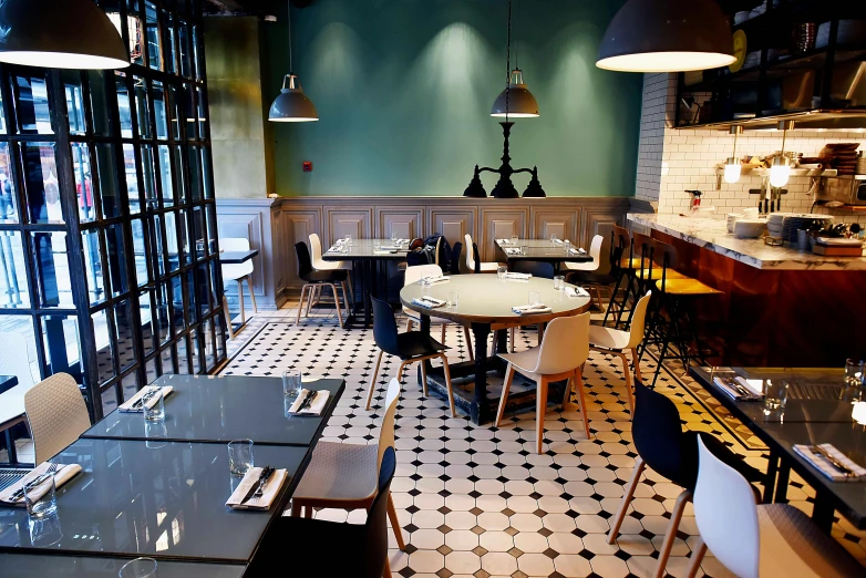 an empty restaurant with tables and chairs, lights and window curtains