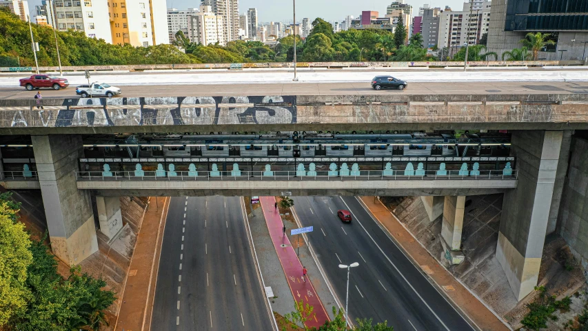 a bridge over a highway with cars on it, inspired by Francis Souza, graffiti, cyberpunk elevated train, brazil, exterior photo, getty images