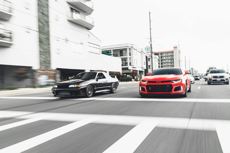 two cars on a city street, both driving towards one another