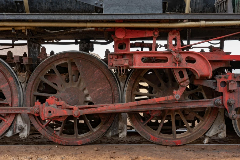 a close up of the wheels of a train, a portrait, by Peter Churcher, large scale photo, preserved historical, digitally painted, half red