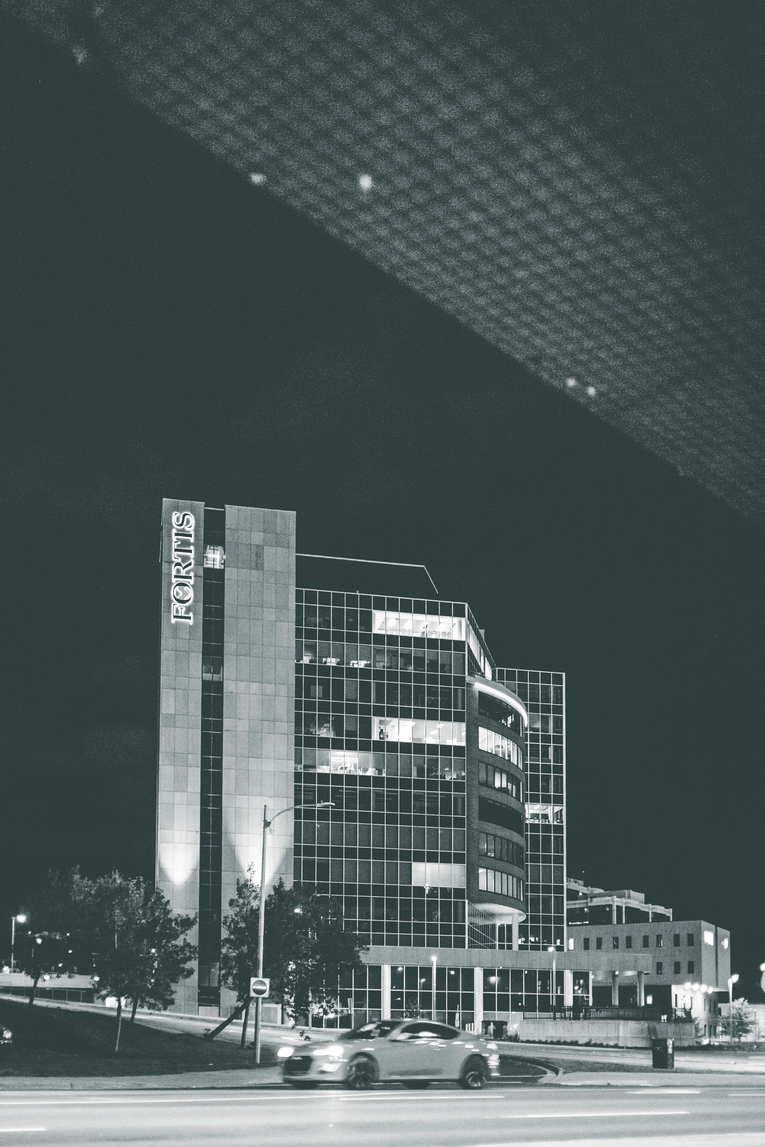 a black and white photo of a city at night, pexels contest winner, brutalism, southdale center, morphosis, snapchat photo, office building