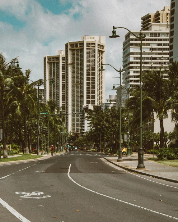 an empty street with tall buildings along both sides