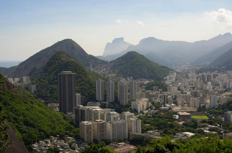 a view of a city with mountains in the background, a photo, brazil, avatar image, getty images proshot, lush surroundings