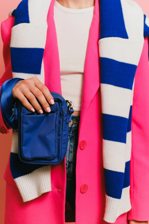 a woman in a pink coat holding a blue purse, solid colours material, zoomed in, holster, cobalt blue