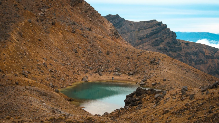 a mountain with a body of water in it