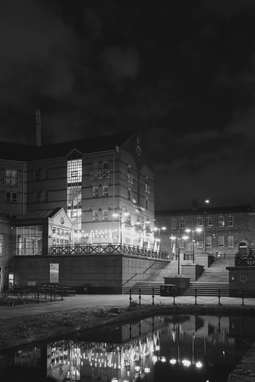 a black and white photo of a building at night, a black and white photo, heidelberg school, ( ( photograph ) ), aardman studios, paisley, set photograph