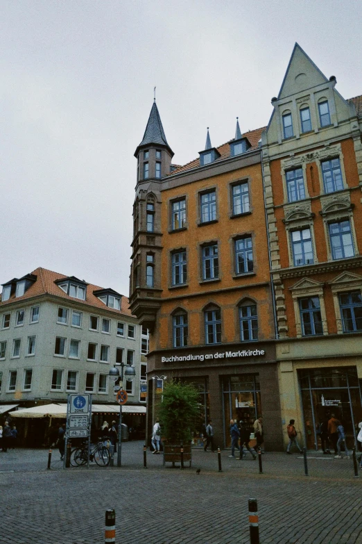 many people in a city square and buildings