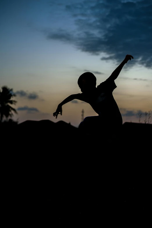 a person stretching on the ground with a sunset in the background