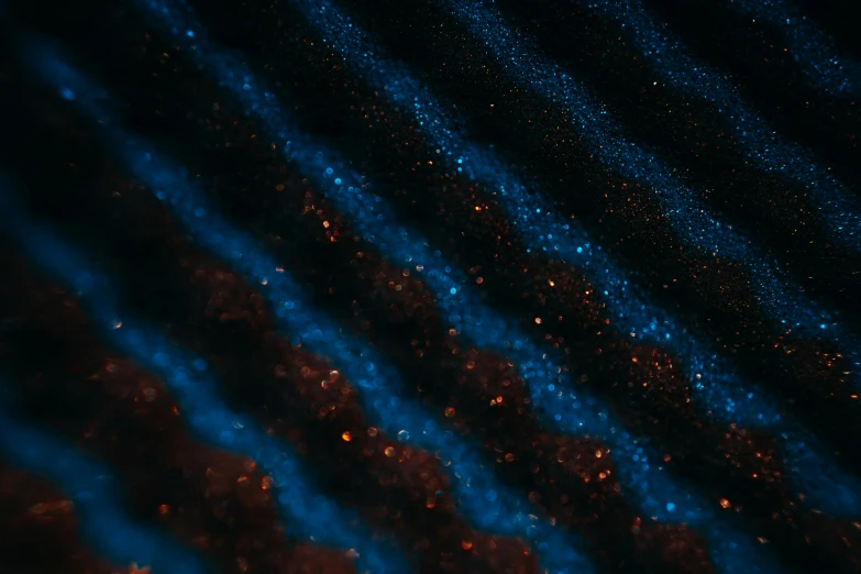 a close up of a grill on a grill, a microscopic photo, by Adam Marczyński, unsplash, generative art, dark blue + dark orange, glitter gif, wave frequencies, blue sand