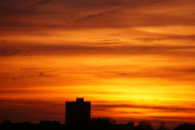 a plane flying in the sky at sunset, by Jan Tengnagel, skyline showing, orange, silhouette :7, spring evening