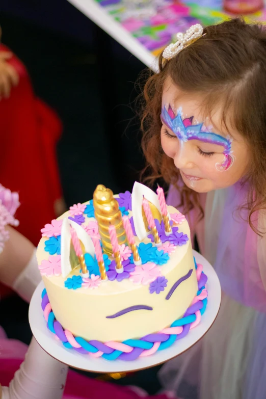 a little girl blowing out candles on a birthday cake, unicorn horn, closeup of face melting, profile image