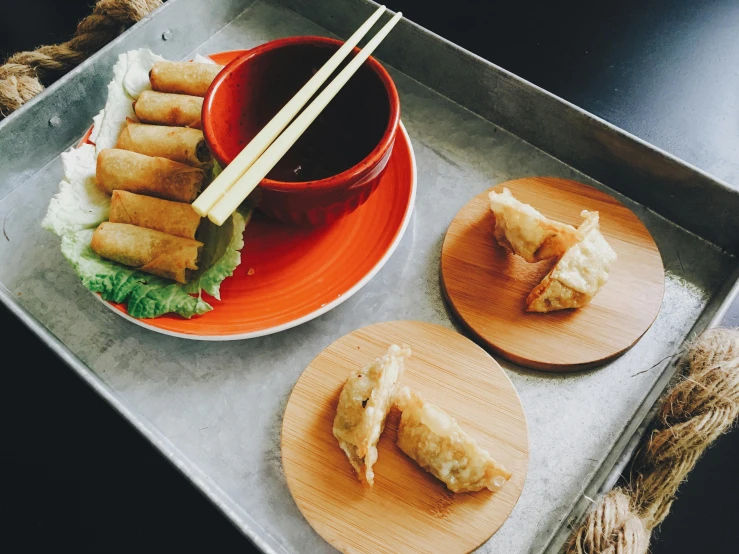 a tray that has some food on it, inspired by Mi Fu, unsplash, square, battered, bamboo, melbourne