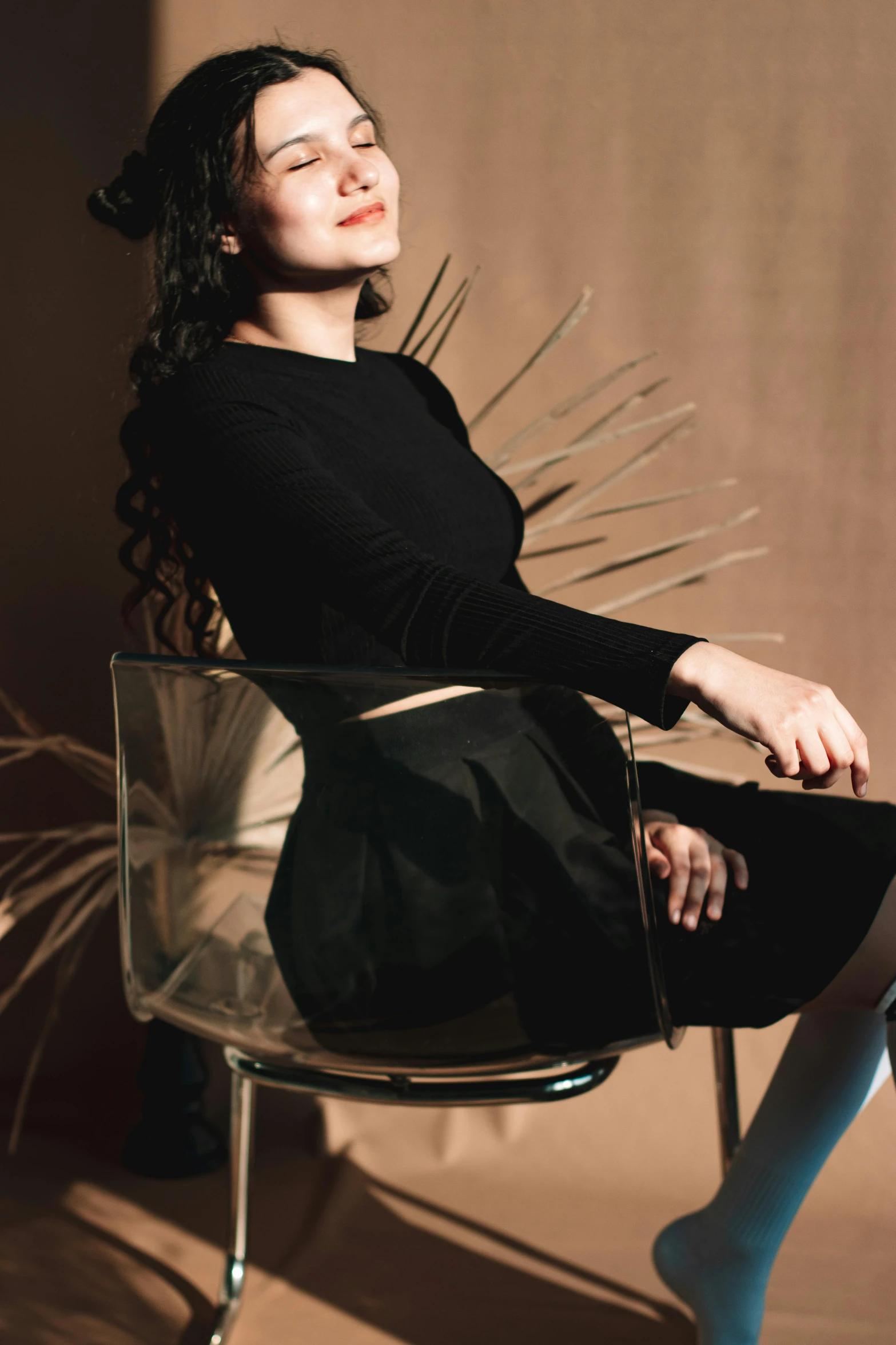 a woman in a chair with a plant