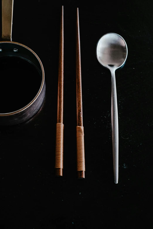 a couple of chopsticks sitting next to a bowl of soup, metal kitchen utensils, thumbnail, curated collection, at midnight