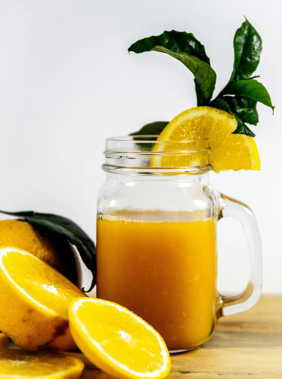 a jar of orange juice next to sliced oranges, by Carey Morris, pexels, detailed product image, greens), yellow mist, made of drink